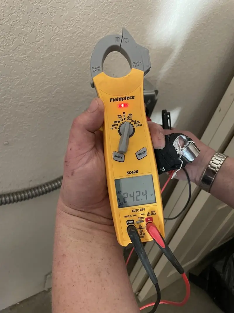 Voltage testing with clamp meter during Outlet Installation in Rochester